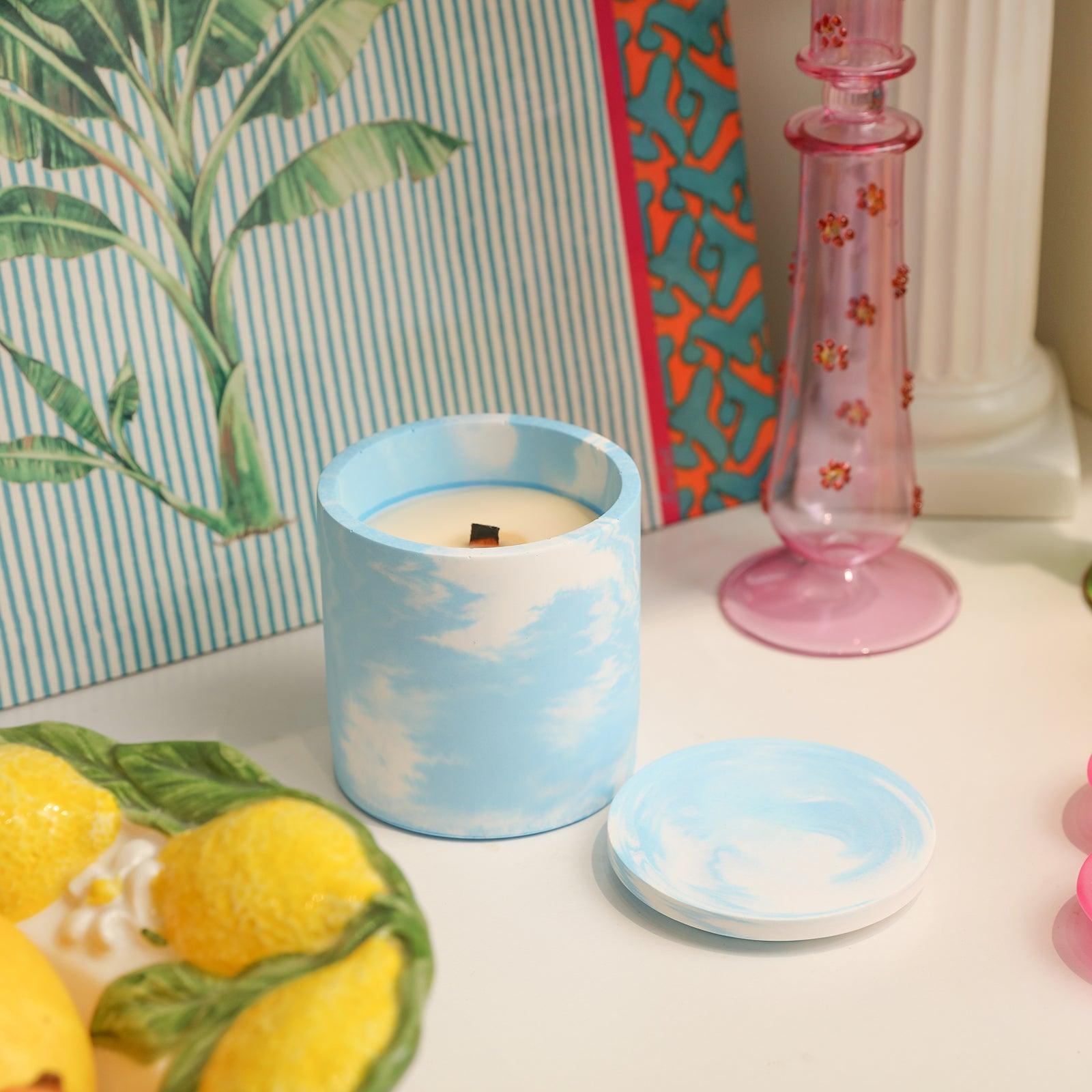 Blue and white candle jars on table, beautiful decor.