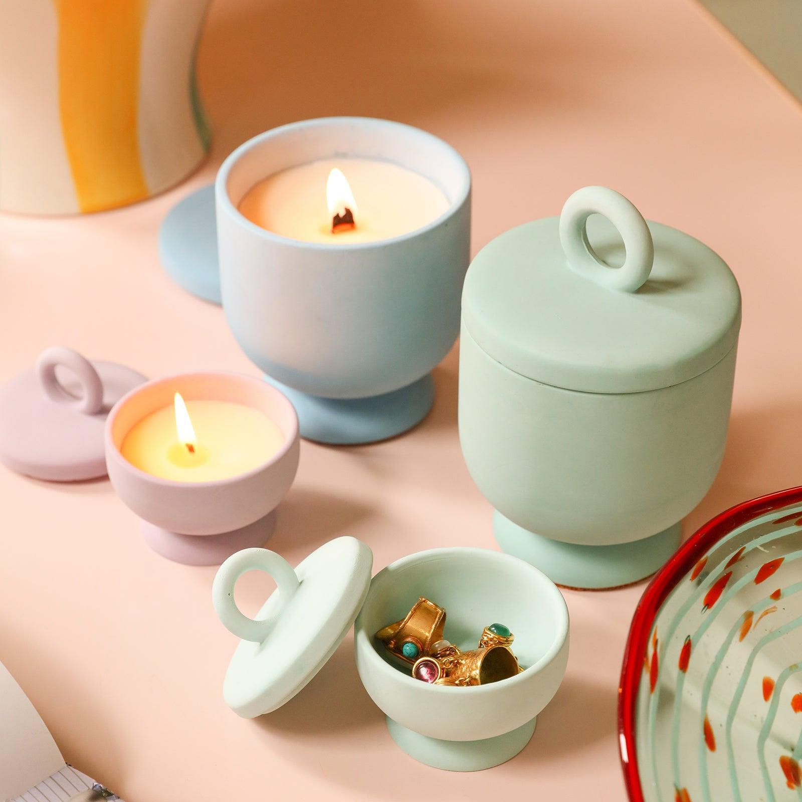 The candles in the large blue and small pink Chalice Candle Jars are burning slowly, and the pink Chalice Candle Jar next to them contains rings -Boowan Nicole