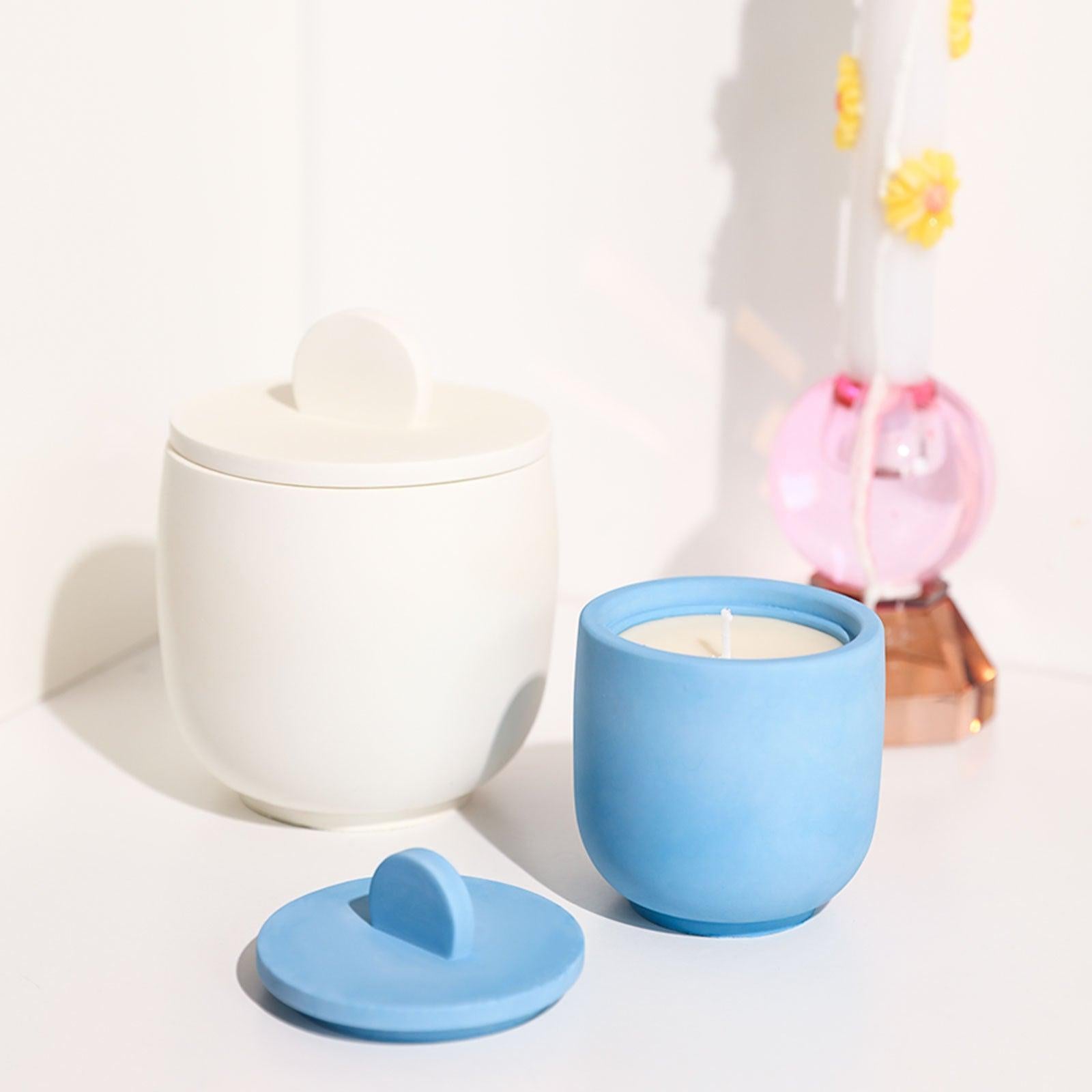 Display of White and Blue Candle Jars with Handles; White Jar Slightly Larger than Blue