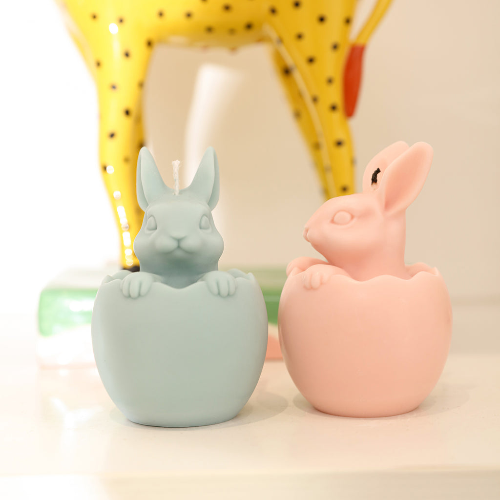 A yellow and blue Easter bunny candle