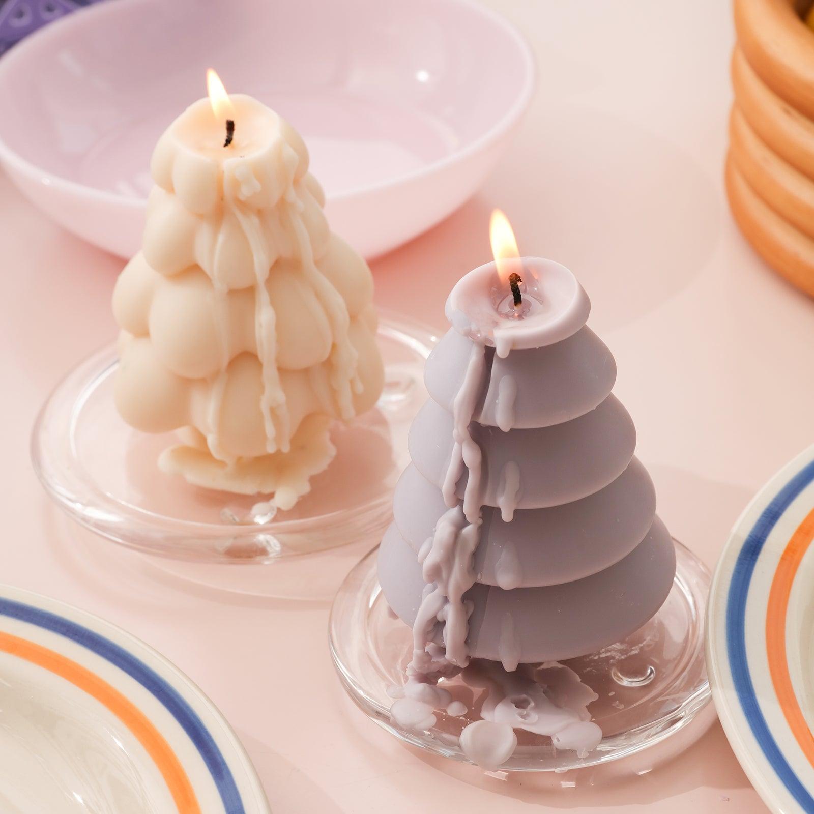 Candles placed on two glass trays with melted wax dripping onto the trays - Boowan Nicole