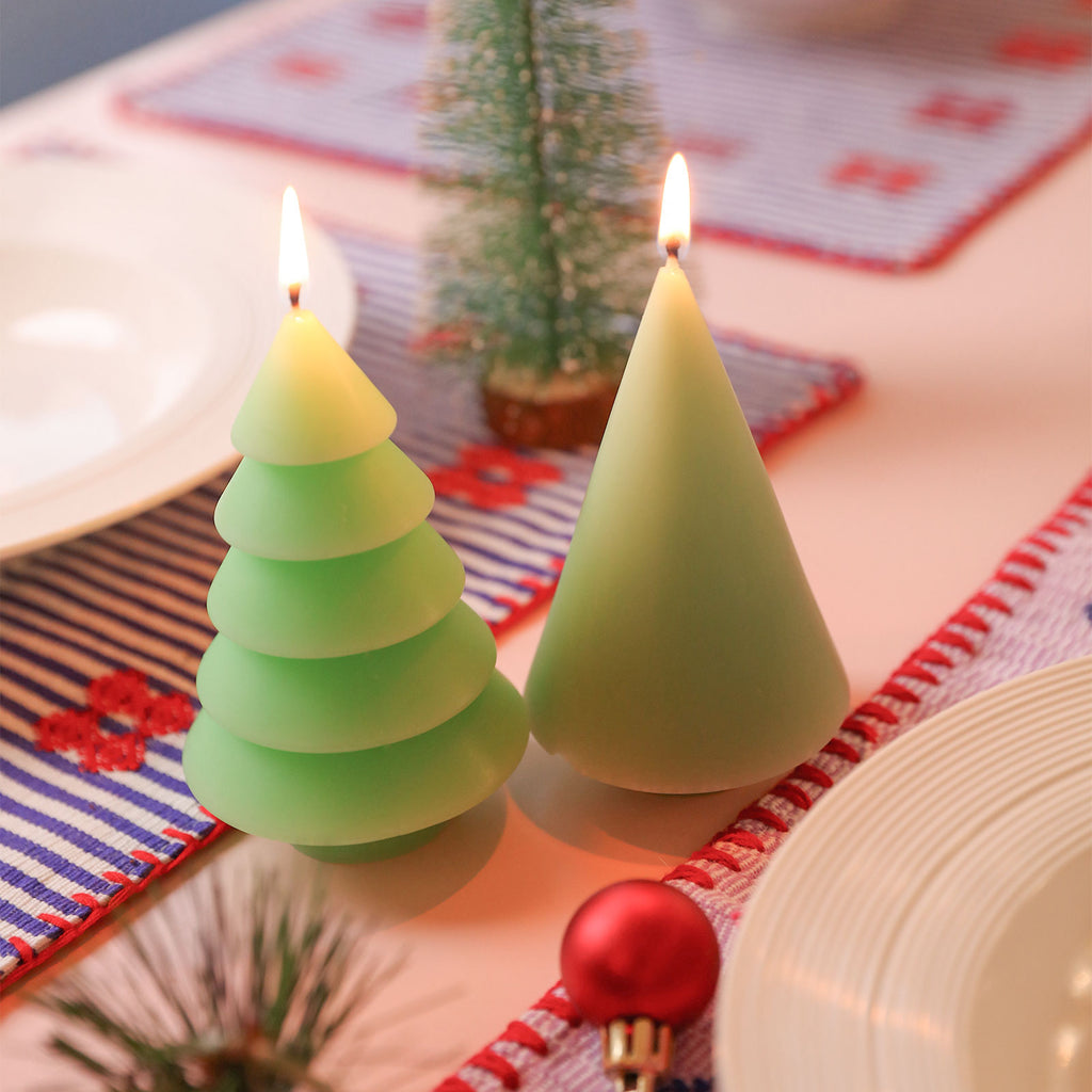 Green layered Christmas tree candles being lit - Boowan Nicole