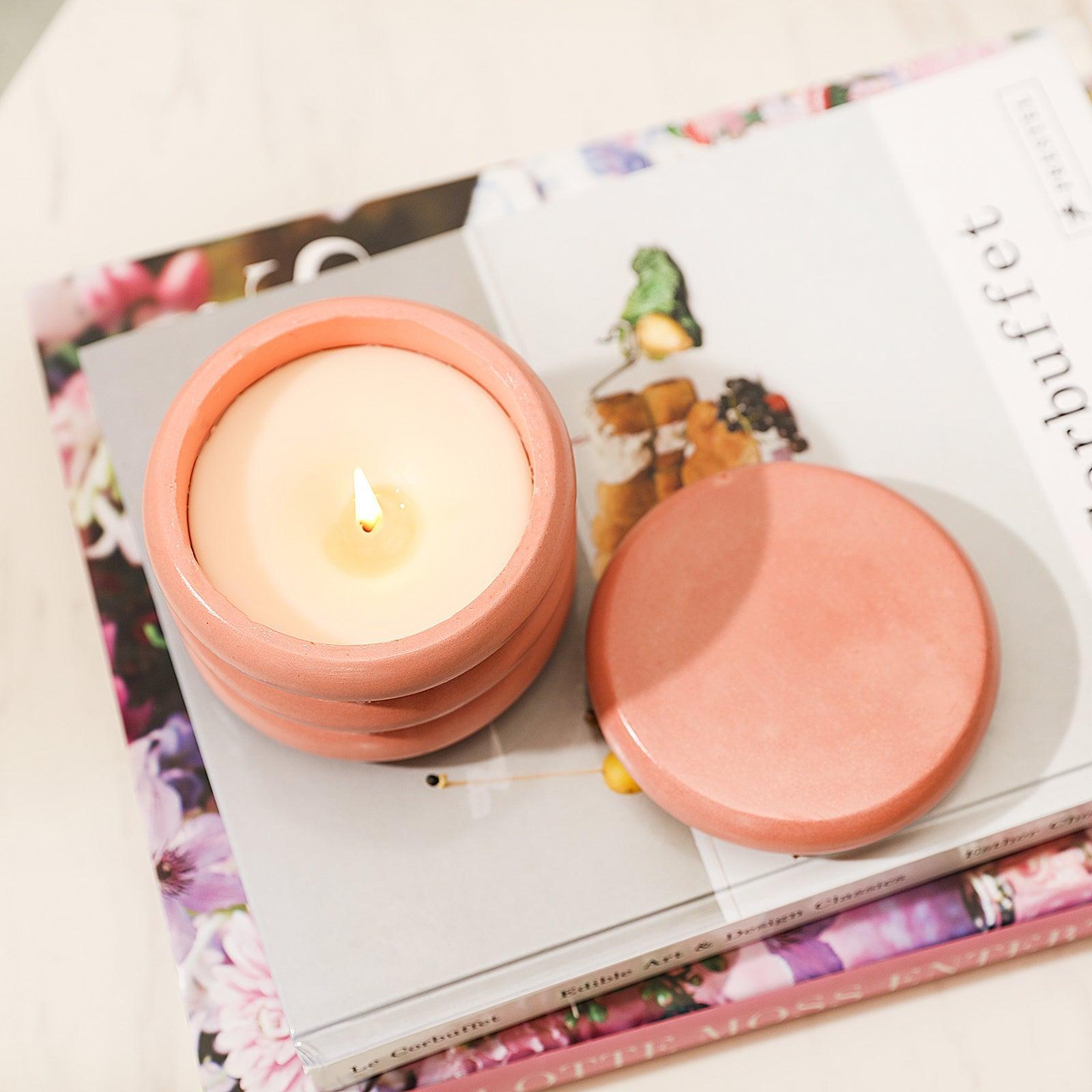 The candle jar placed on top of the book is lit, revealing tranquility.