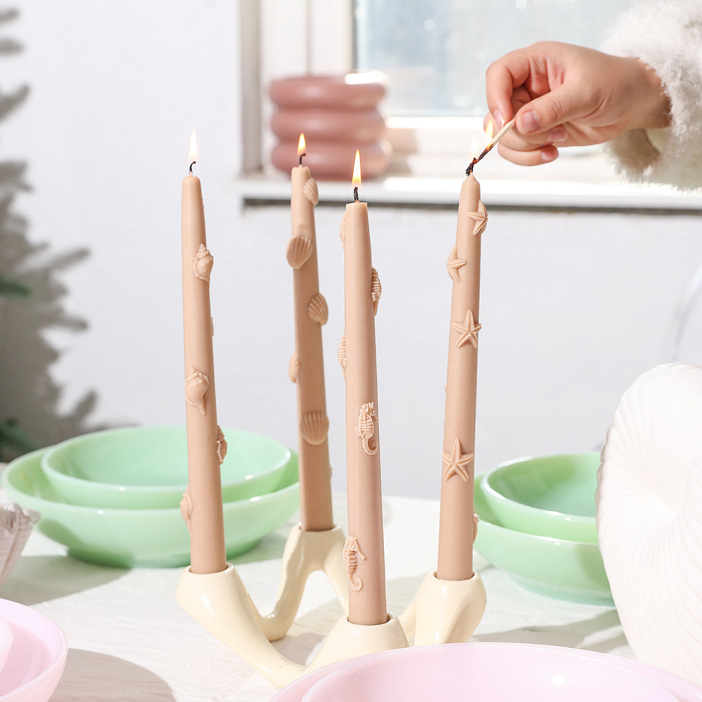 Light the Ocean Collection Taper Candle in a four-branch candlestick.