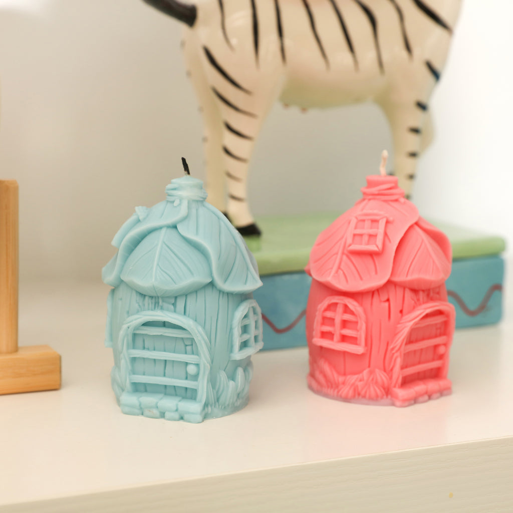 Blue and pink fairy tale mushroom house candles placed at home as decoration-Boowan Nicole