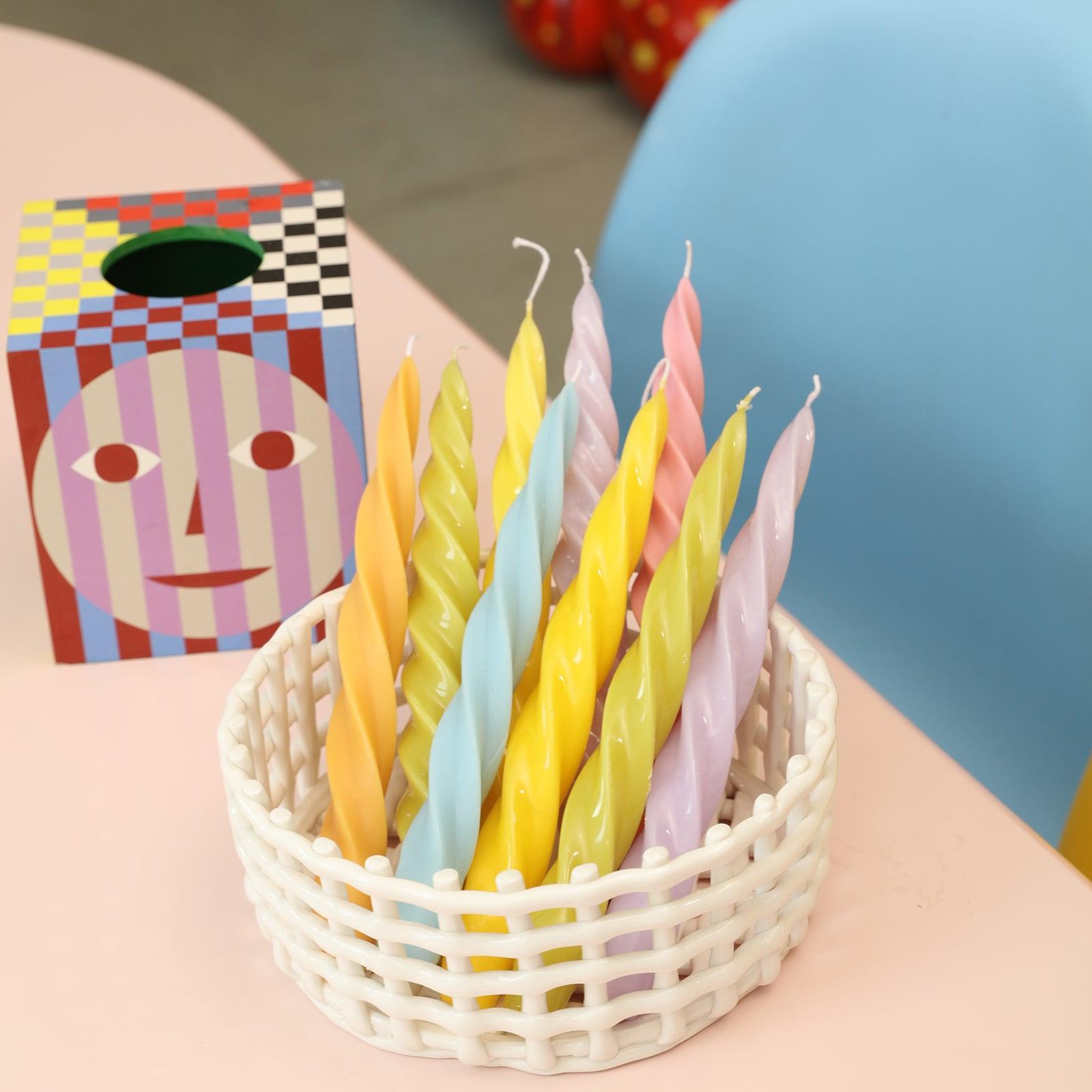 Spiral taper candles crafted with Boowannicole silicone molds, artfully arranged in a basket