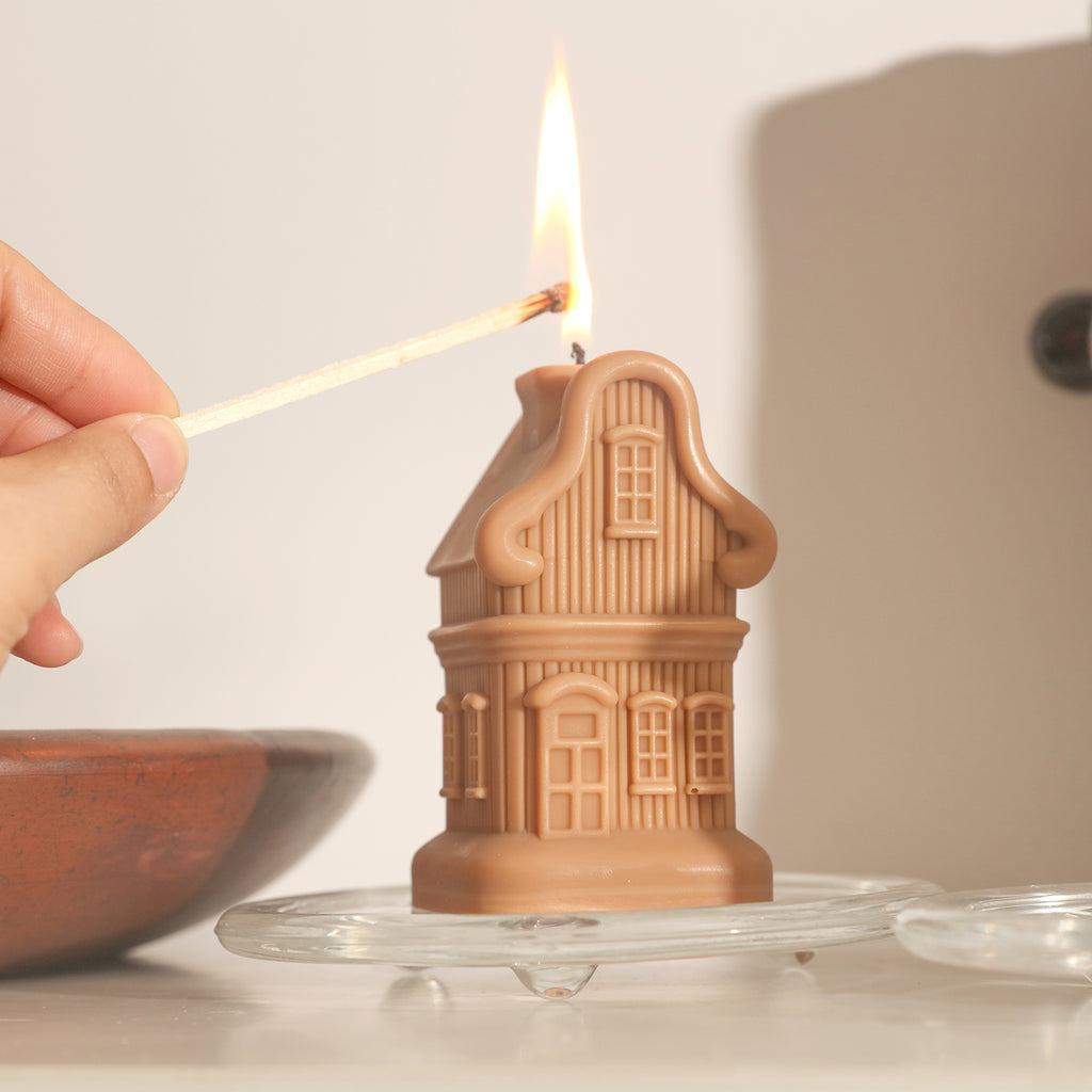 Light the brown house candle on a crystal tray by Boowan Nicole.