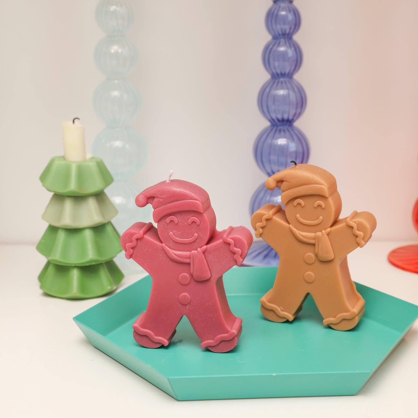 Red and brown Gingerbread Baby candle on tray on tabletop - Boowan Nicole