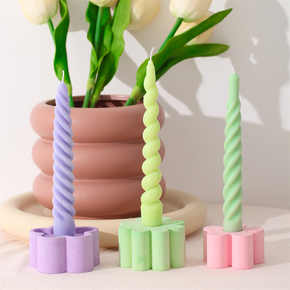 Three uniquely shaped and colored candles, crafted with Boowannicole's silicone molds, elegantly displayed on candle holders, showcasing the brand's exquisite craftsmanship.