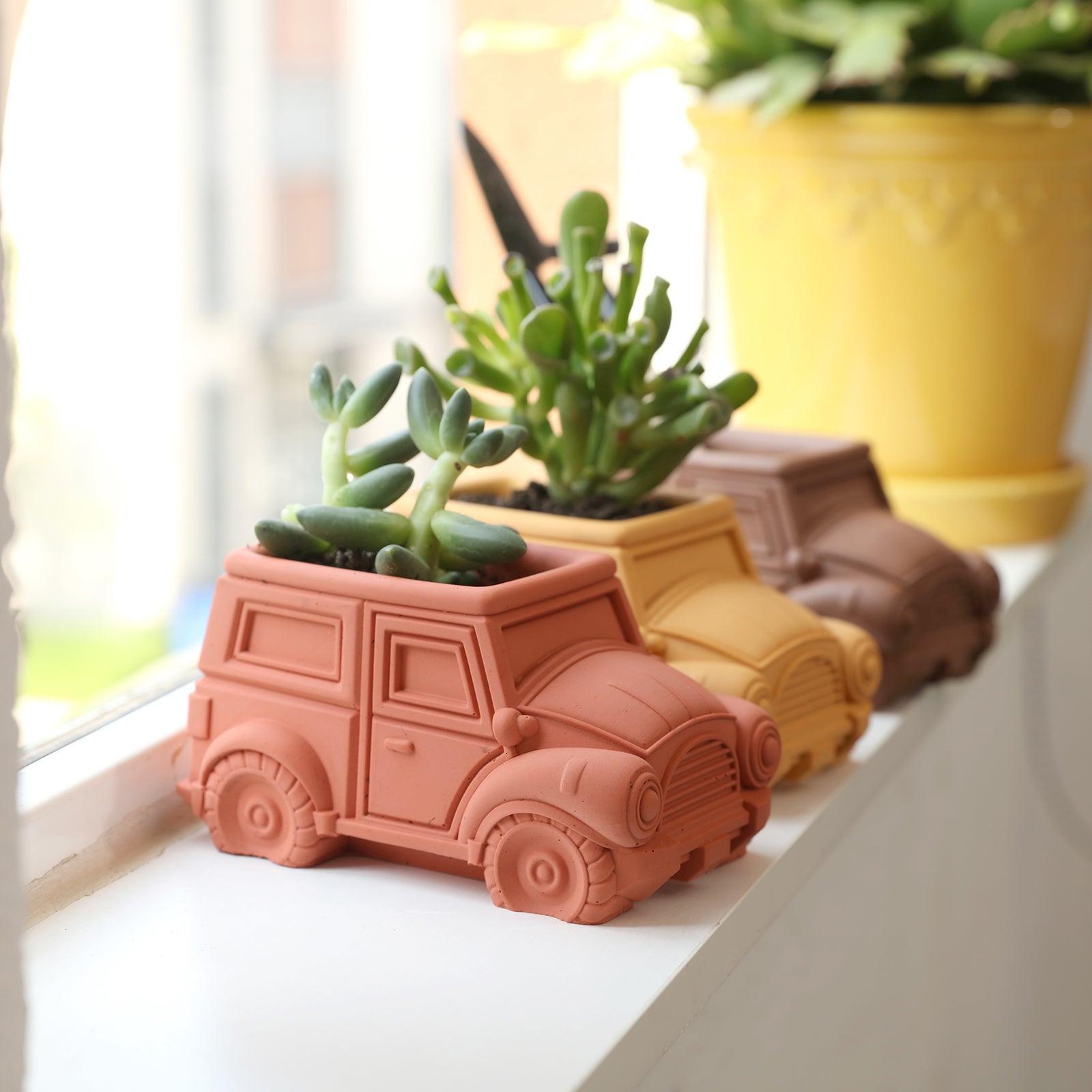 Three Vintage Off-Road Car Plant Pot Concrete-Boowan Nicole with plants on the windowsill