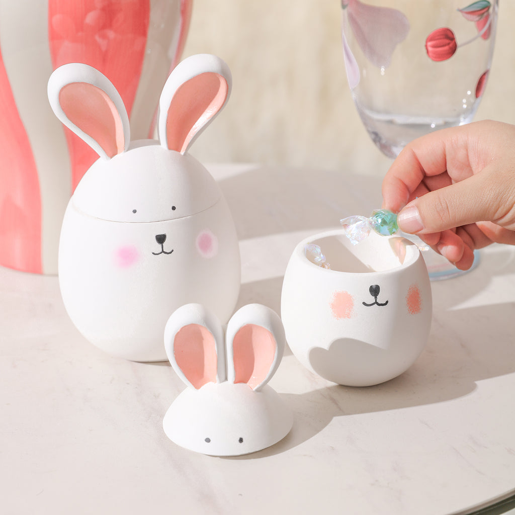 Putting candies into the bunny candle jar