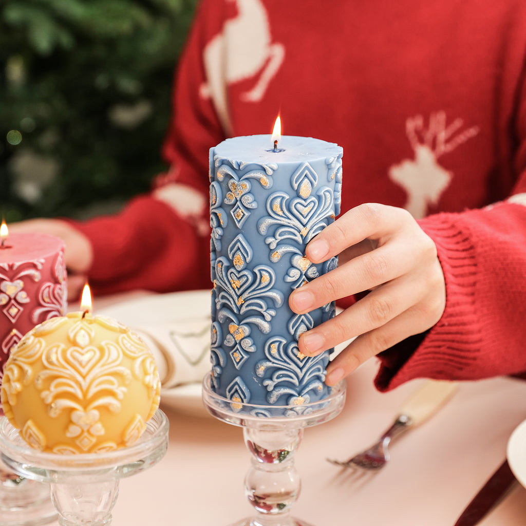 Ignited blue relief patterned pillar candle with gold accents, dazzling and vibrant.