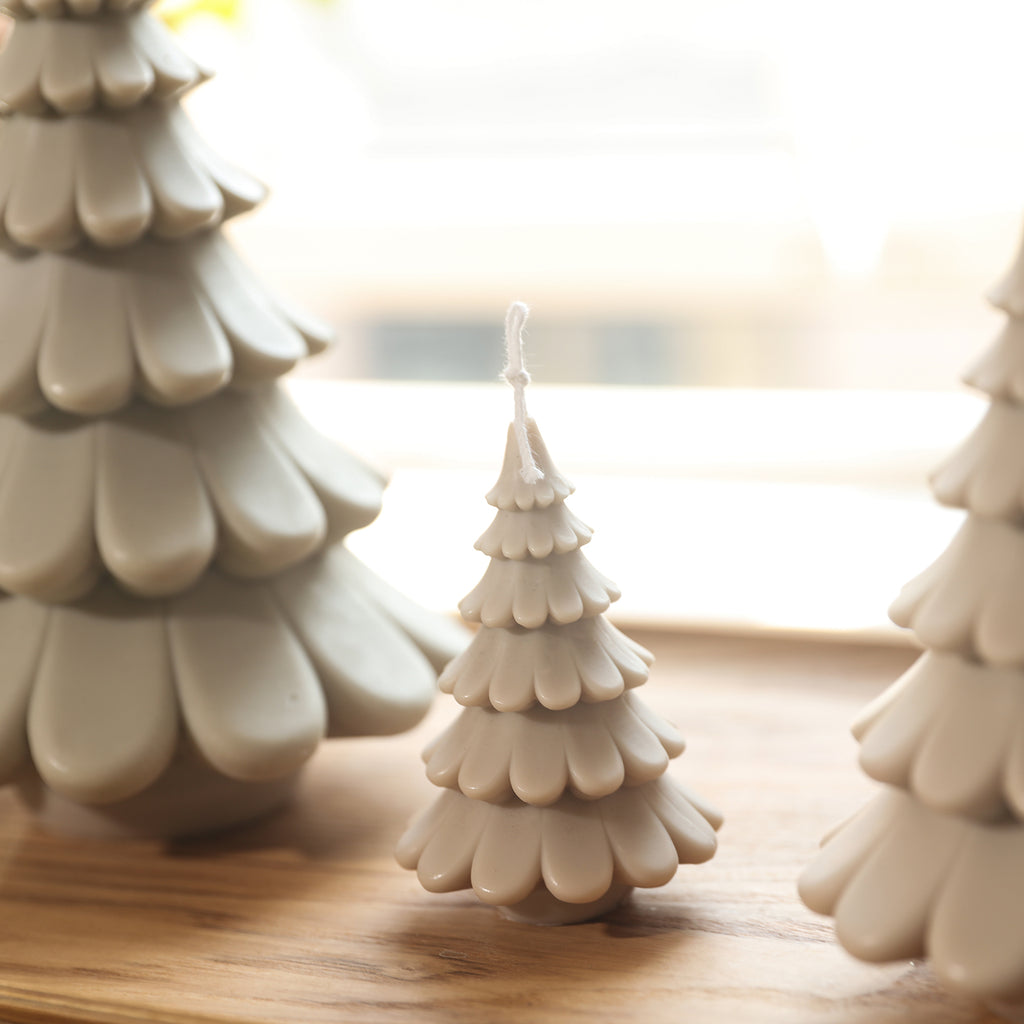 4-inch off-white Christmas tree candles arranged on a tray, designed by Boowan Nicole.