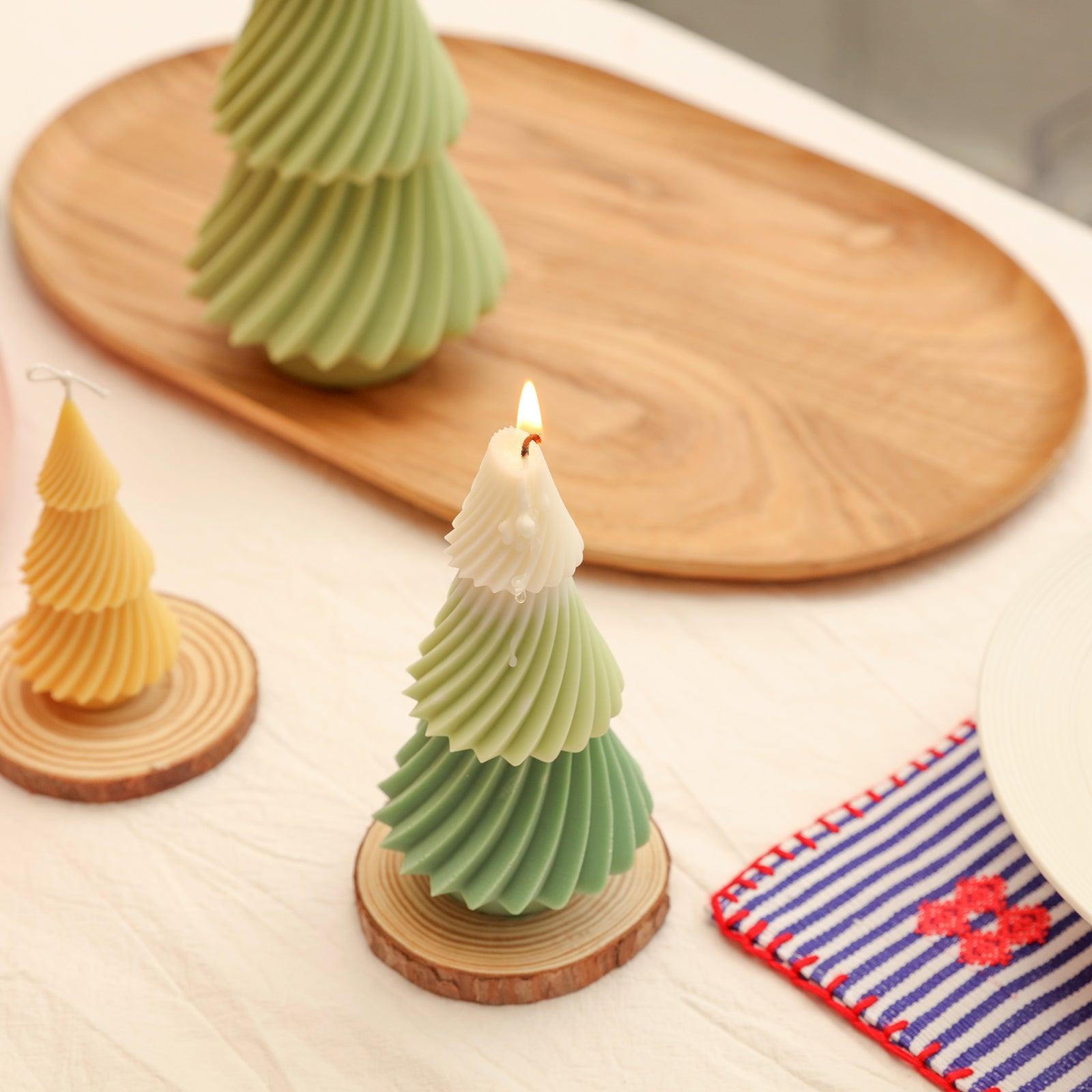 The purple 6.5-inch evergreen Christmas tree candle placed on the wooden tray of the dining table is burning slowly, full of ritual feeling-Boowan Nicole