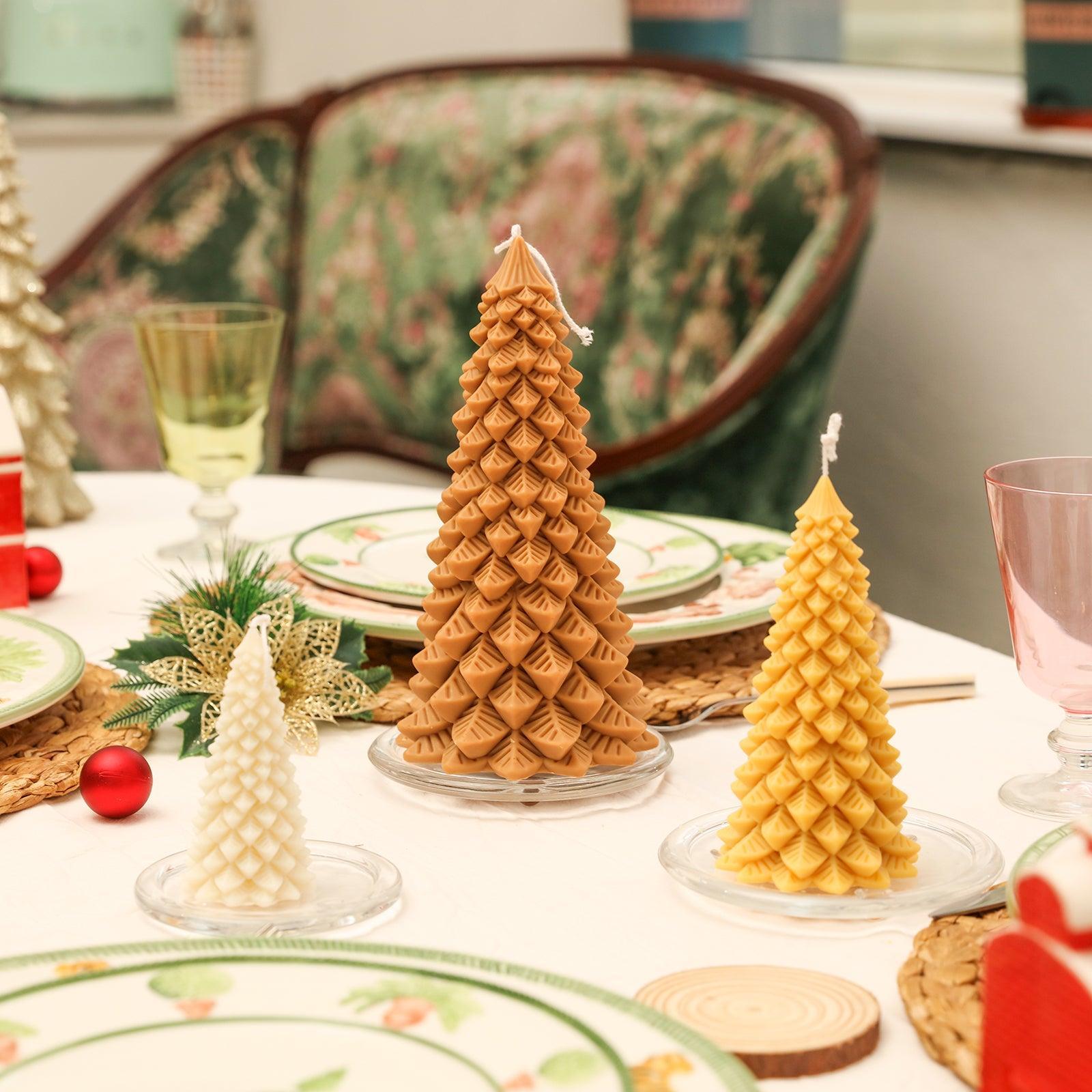 Three Christmas pine candles of different sizes are placed in crystal trays on the tabletop, with the 8.5-inch Christmas pine candle in the center - Boowan Nicole