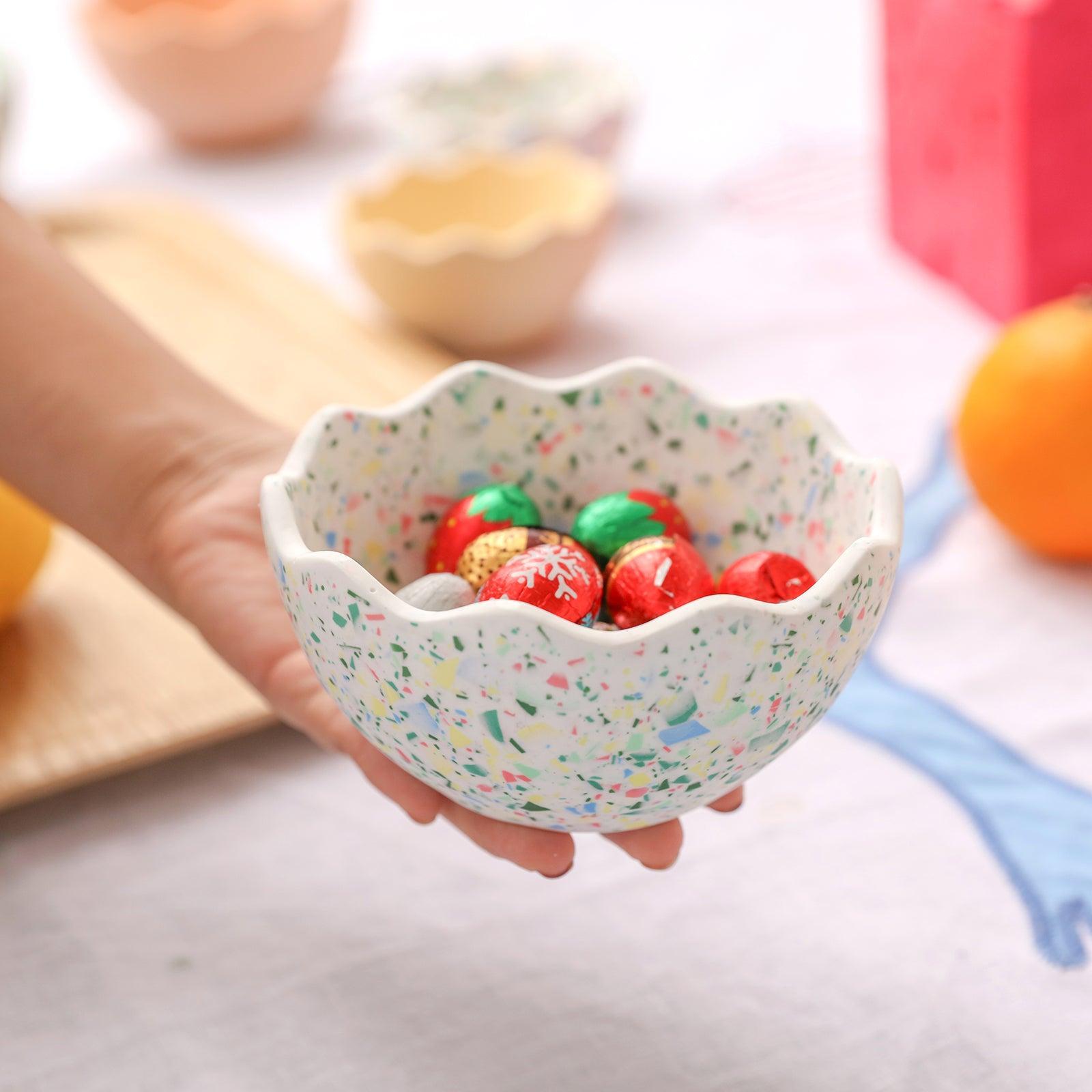 Chocolate colored eggs in an eggshell bowl