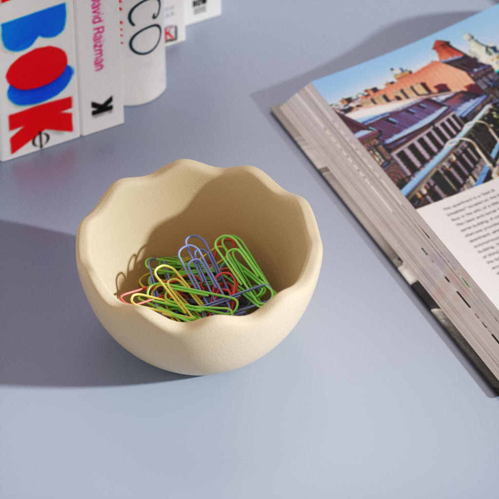 Paper clip in eggshell bowl