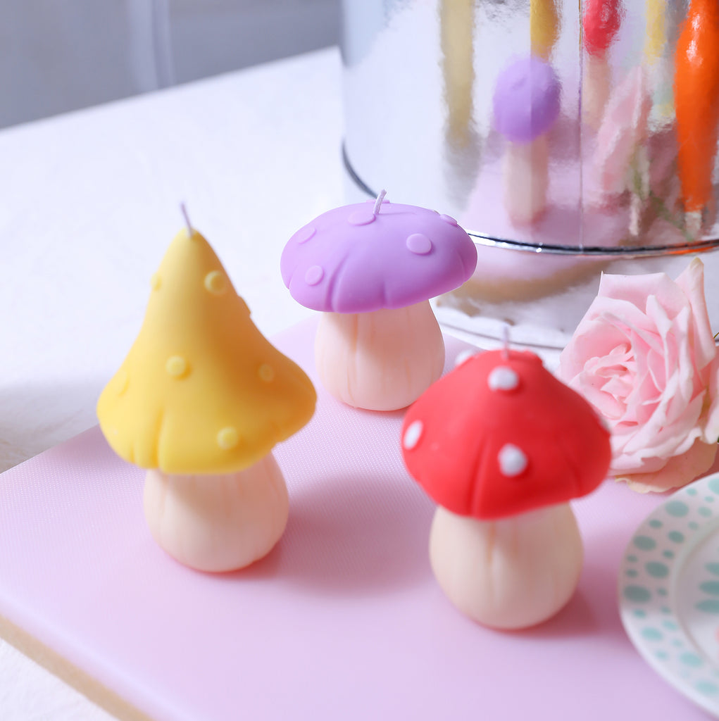 Mushroom-shaped candle with yellow, red and purple canopies, designed by Boowan Nicole.