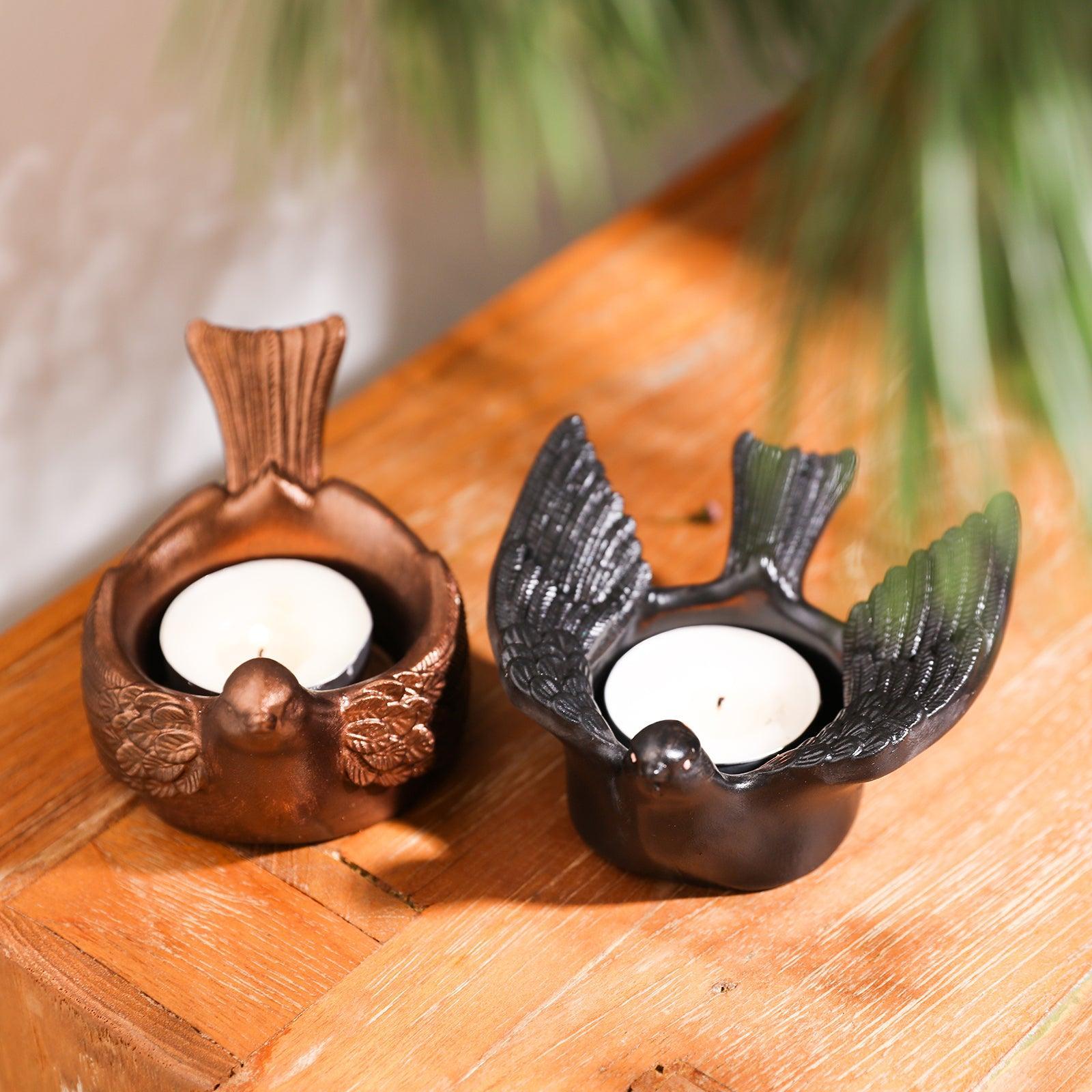 Artistic touch evident as tea light holders brushed with golden and black mica powder are displayed, showcasing unique and elegant designs.