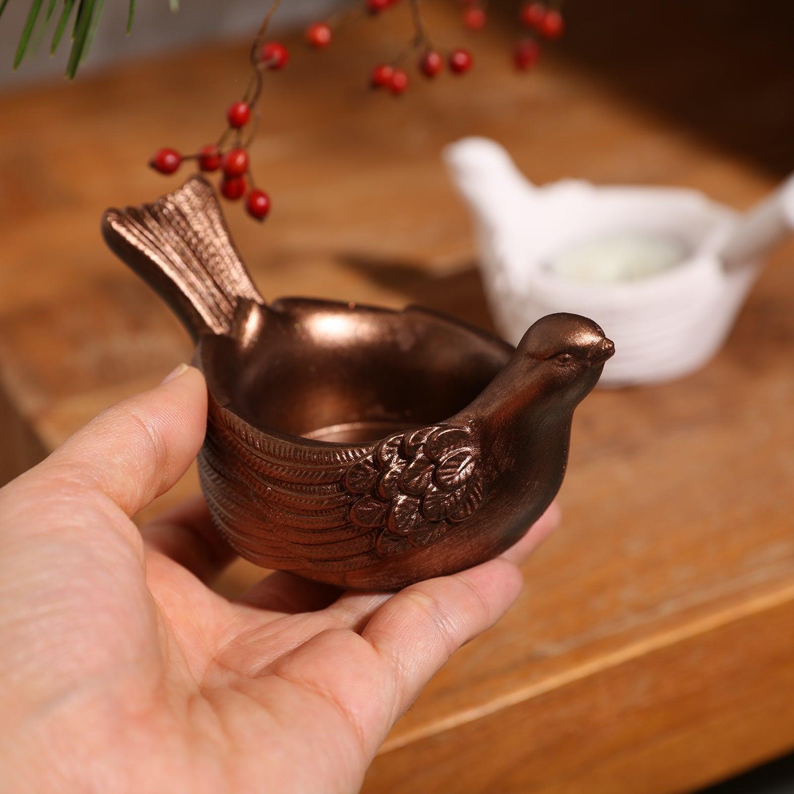A tealight candle holder coated with golden mica powder.