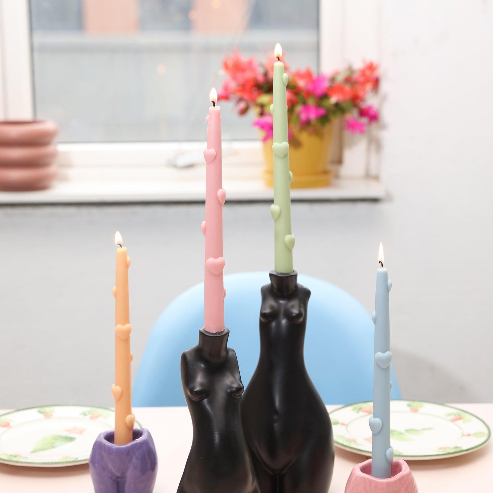 Adorn your dining table with the enchanting ambiance created by four lit Love Heart Taper Candles.