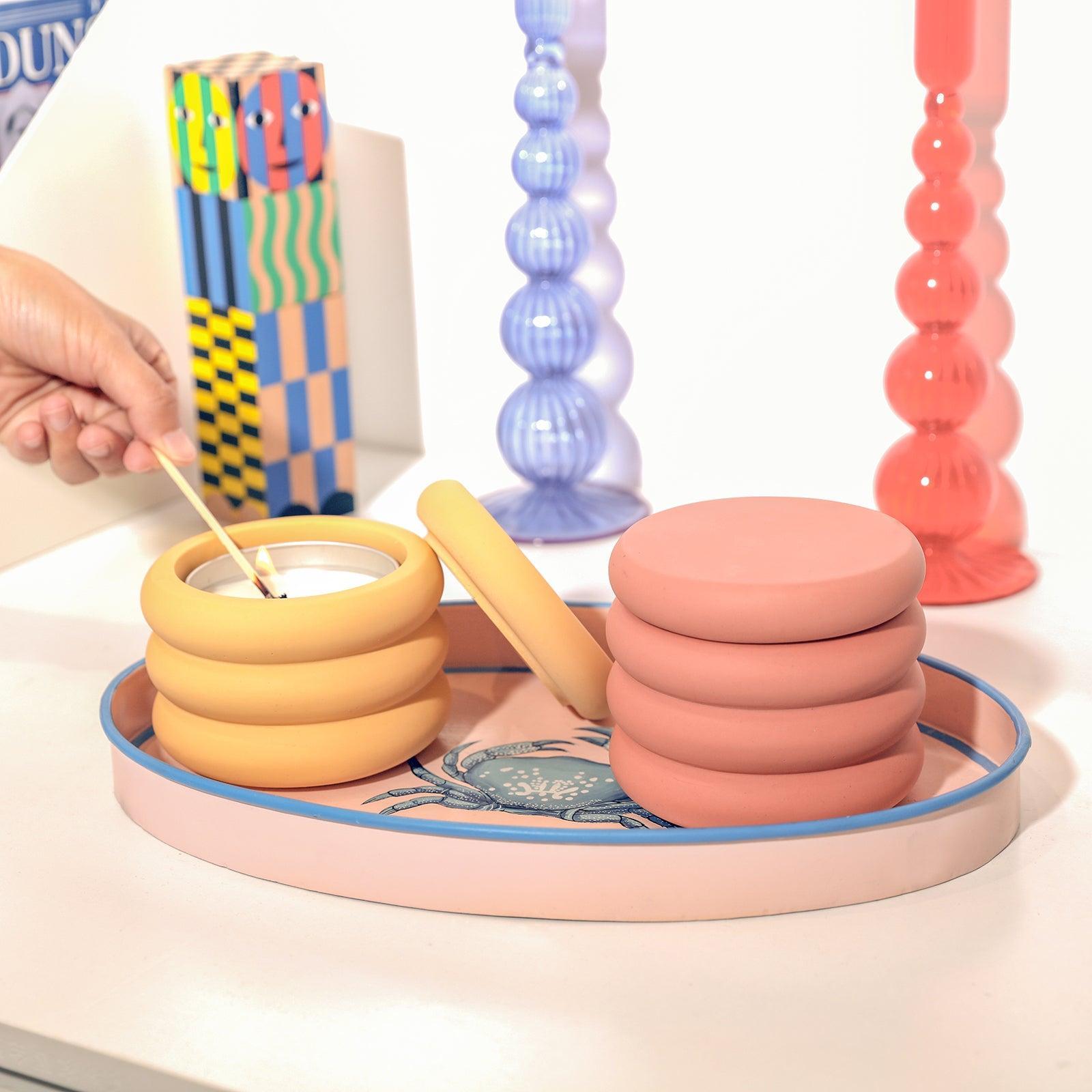 Place the two candle jars on the tabletop tray and light the aluminum can refill candle in the left candle jar.