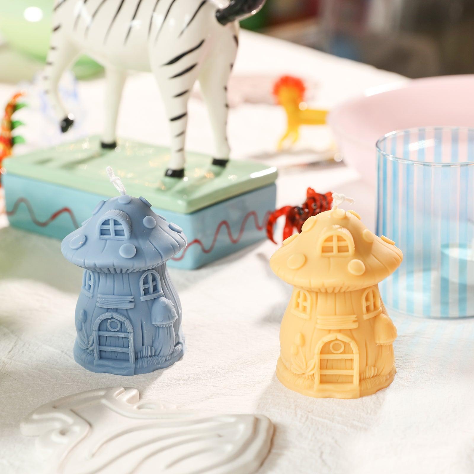 Blue and yellow mushroom house candles on the table, designed by Boowan Nicole.