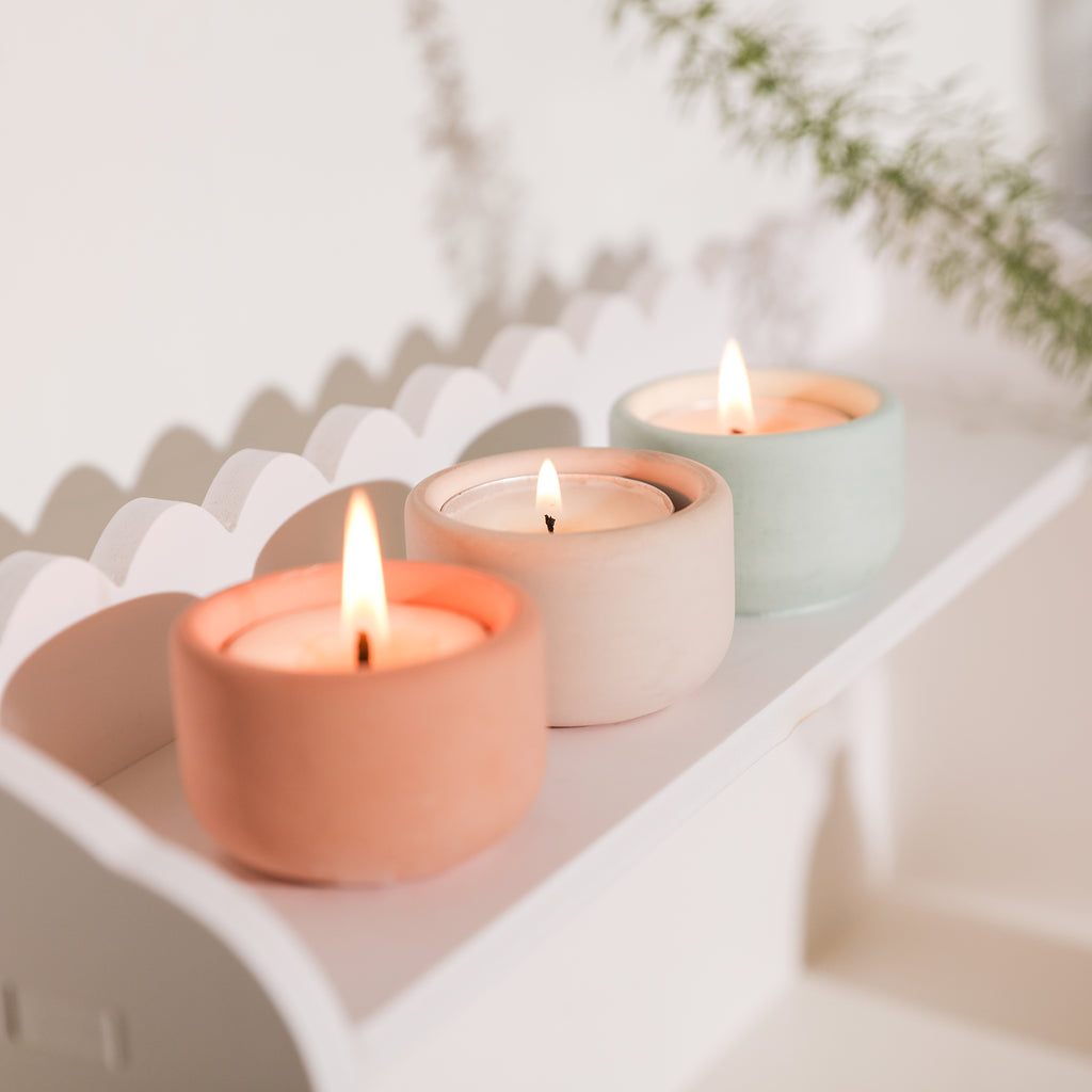 Three candle holders with lit candles, creating a cozy atmosphere.