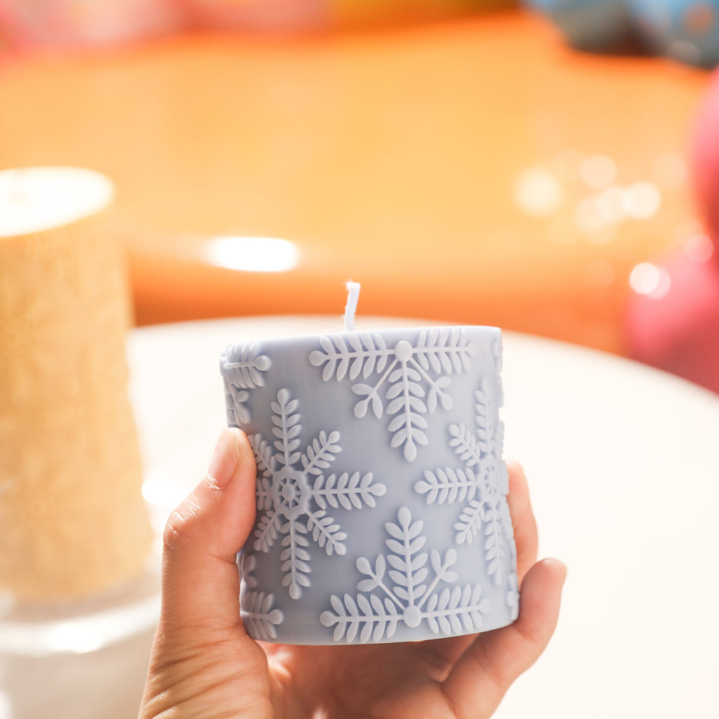 Display the purple snowflake embossed cylinder candle in hand with the Boowan Nicole mold to create wonderful fun.