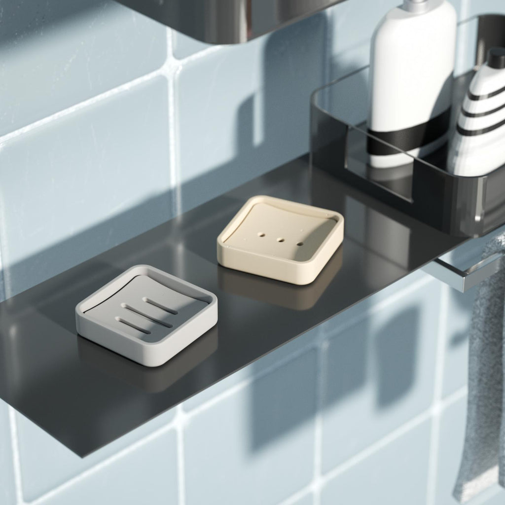 Gray and yellow soap boxes by the sink, with the gray one having a horizontal drain tray and the yellow one having three holes.