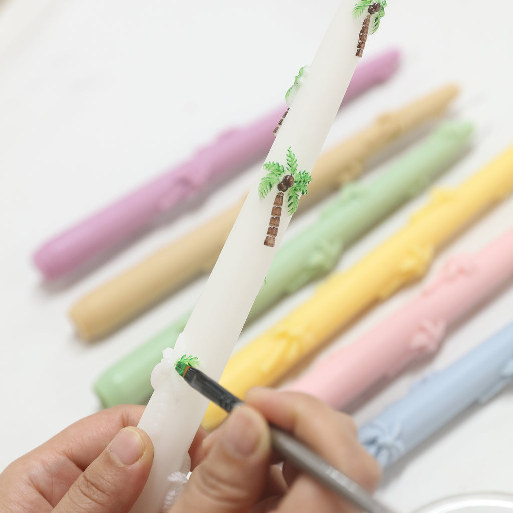 Use colored pencils to color the palm tree relief taper candle.