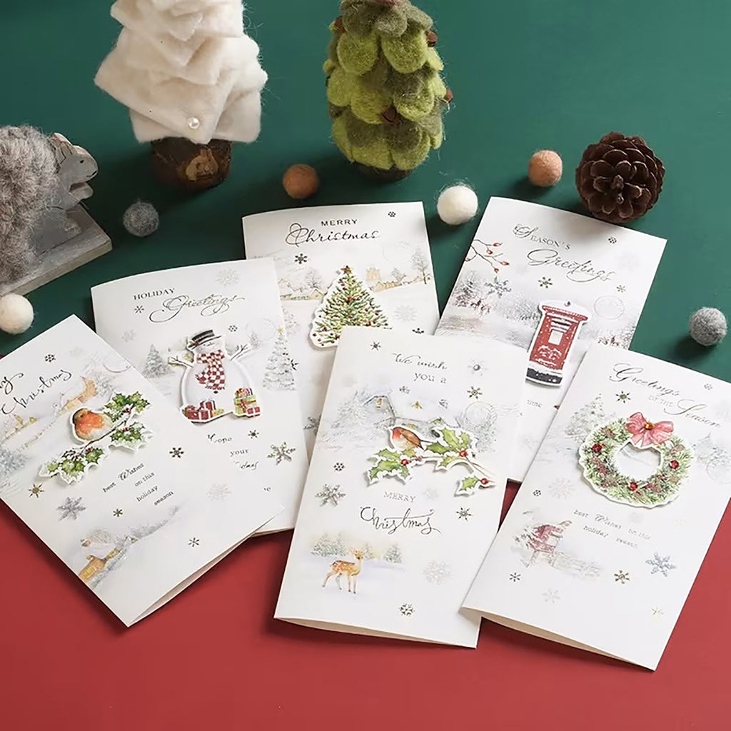 Six greeting cards placed on a table with Christmas decorations -Boowan Nicole