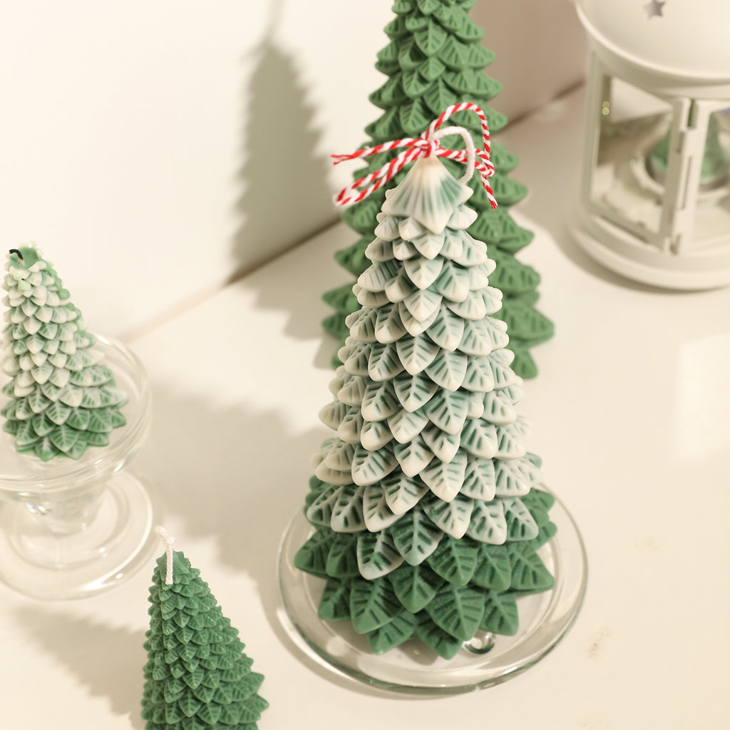 A green and white 8.5-inch Christmas pine candle is placed on the table, with the white part covering it like snowflakes - Boowan Nicole