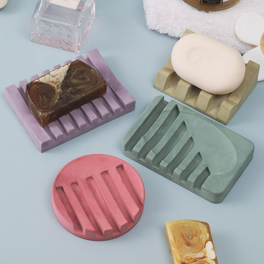 howcasing four soap dishes with different colors and shapes made using silicone molds, highlighting the diversity of boowannicole's design.