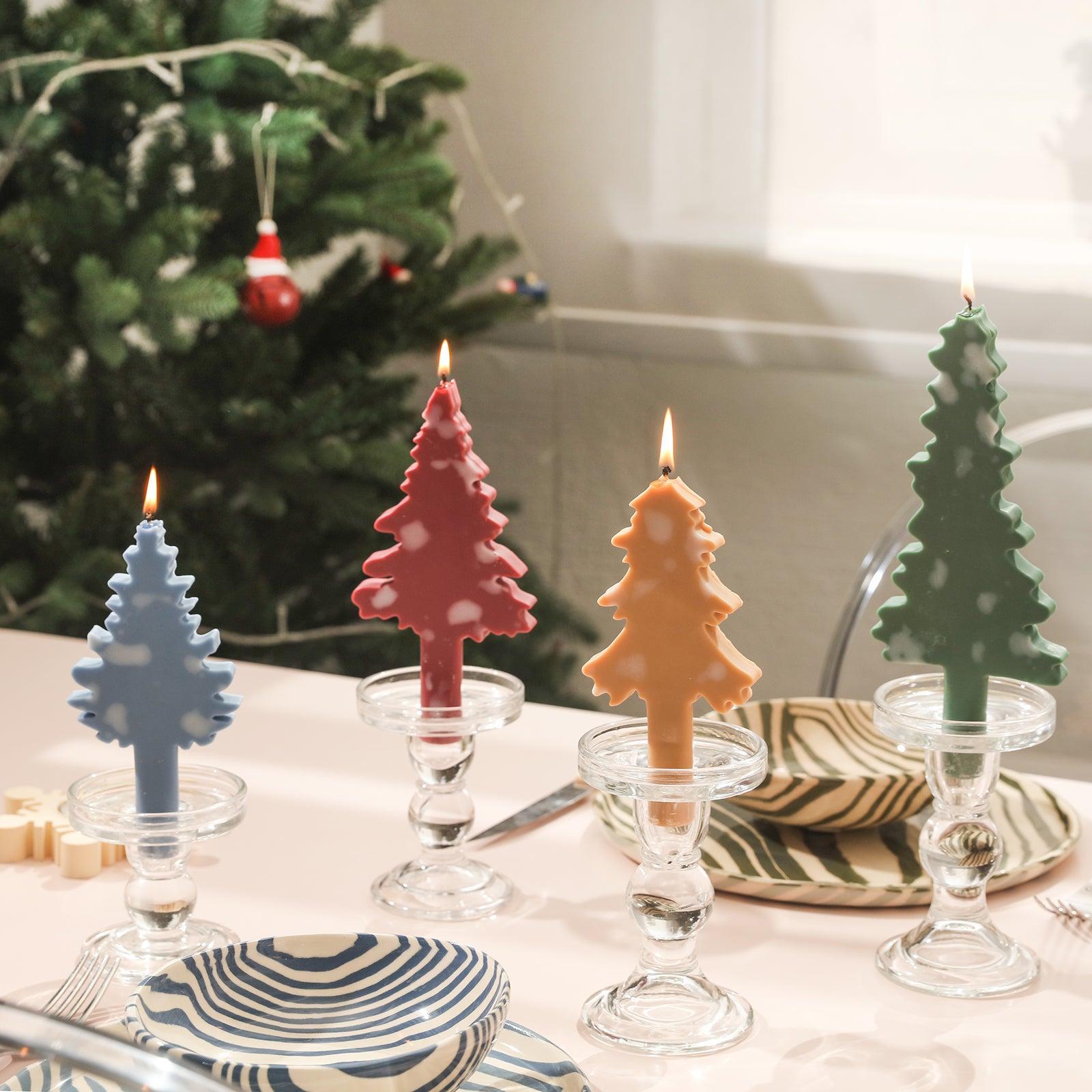Blue, red, yellow, green Christmas candles placed in crystal candle holders on the dining table.