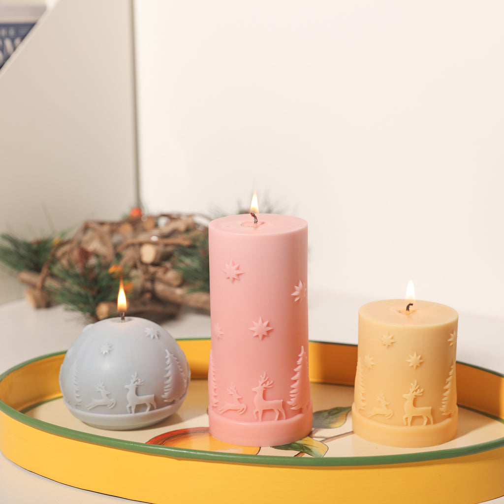 Short yellow, long pink, and purple dome-shaped Christmas pattern candles are placed on the tray with slow burning design Boowan Nicole.