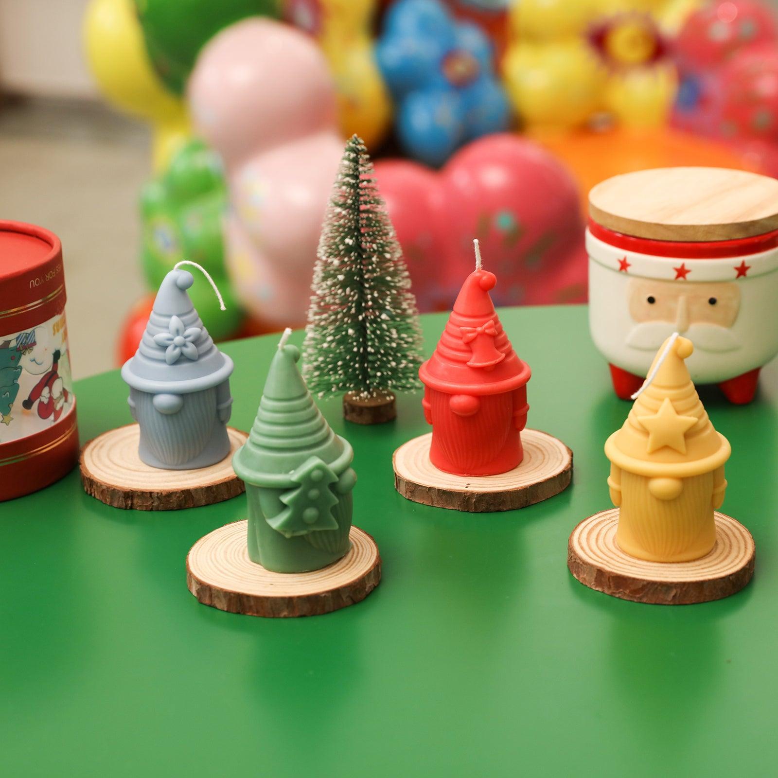 The Stellan of Hat-tactic Gnome Squad Candle in four shapes of purple, green, red and yellow is placed on the table-Boowan Nicole