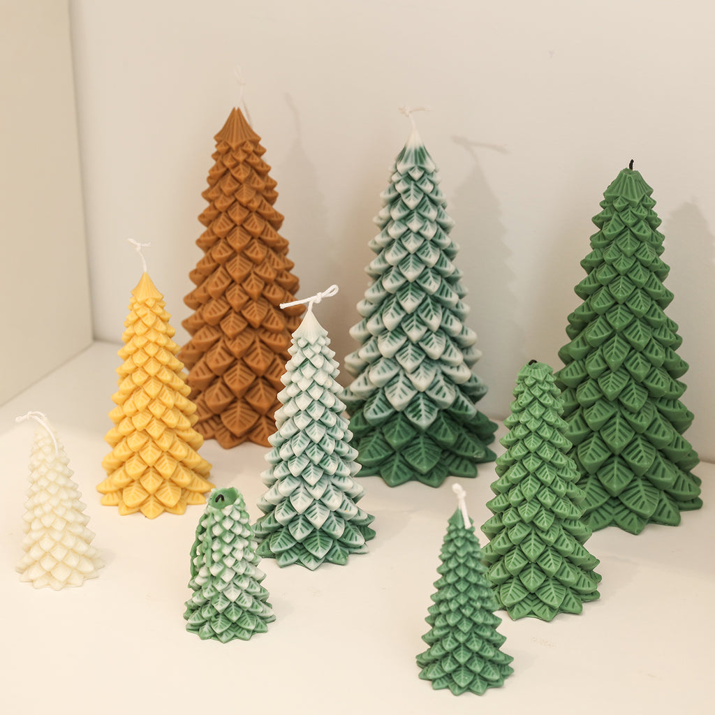 Nine Christmas pine trees of different sizes and colors are placed on the table according to height - Boowan Nicole