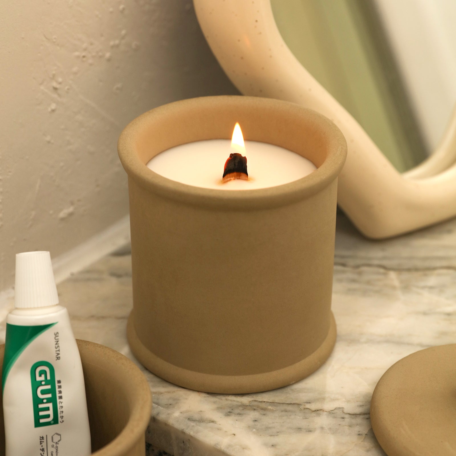 Candles burning slowly in the Cylinder Short Candle Jar on the bathroom sink -Boowan Nicole