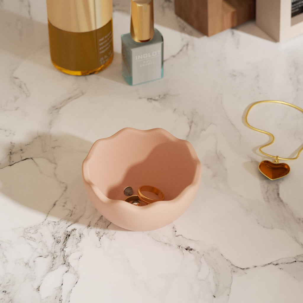 Jewelry in an eggshell bowl in the bathroom