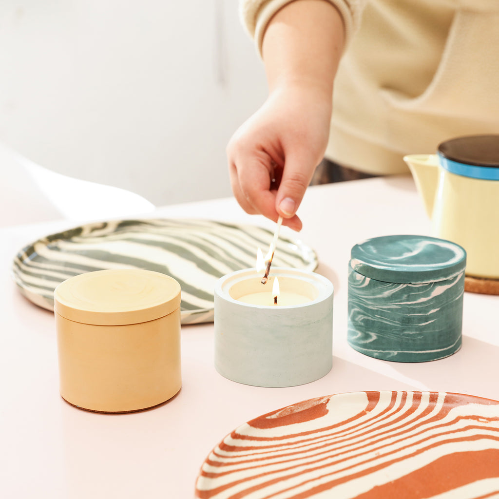 Three candle jars in different colors offer a vibrant selection.