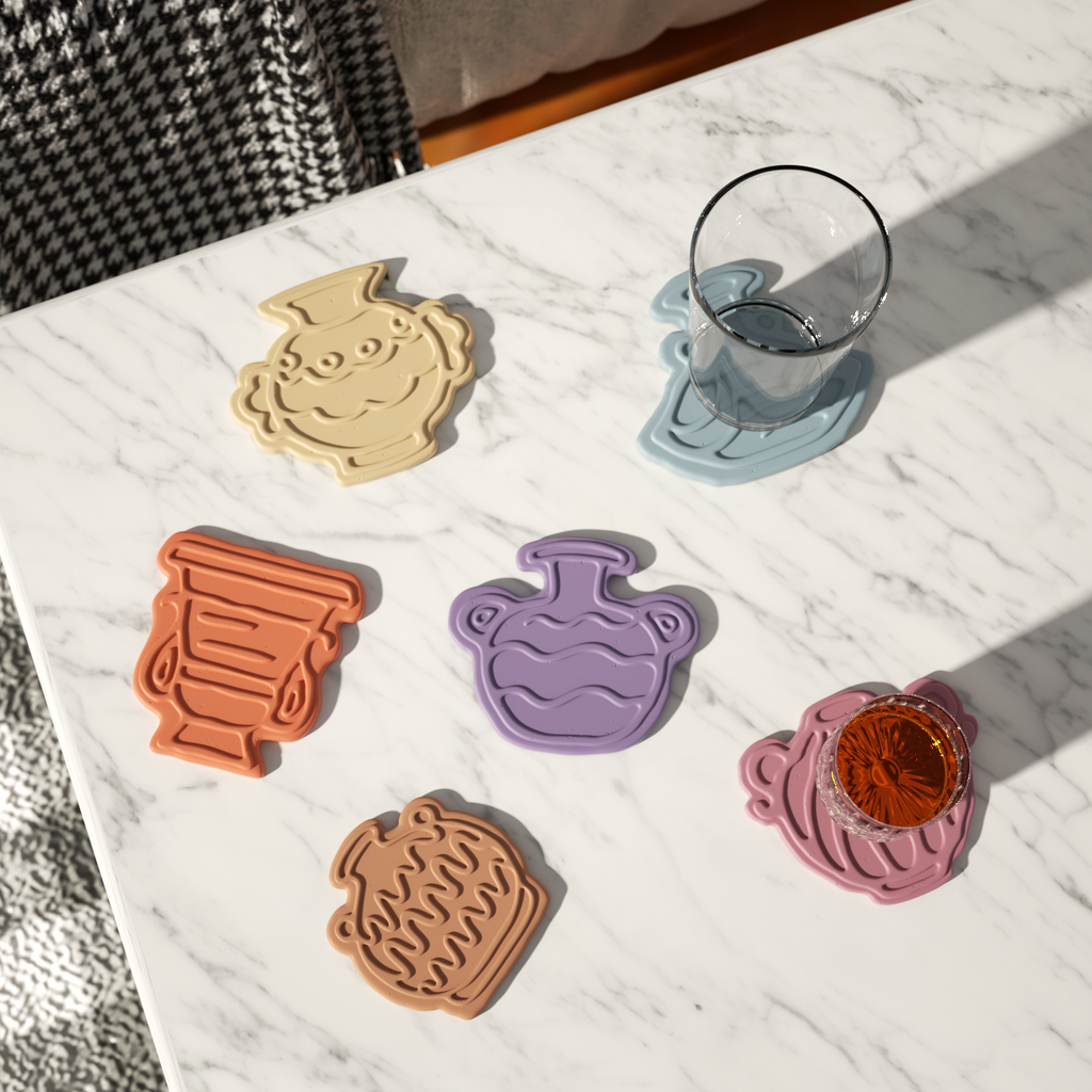 The sun shines on the tabletop, on which are placed classic kettle-shaped coasters of different colors and shapes, designed by Boowan Nicole.