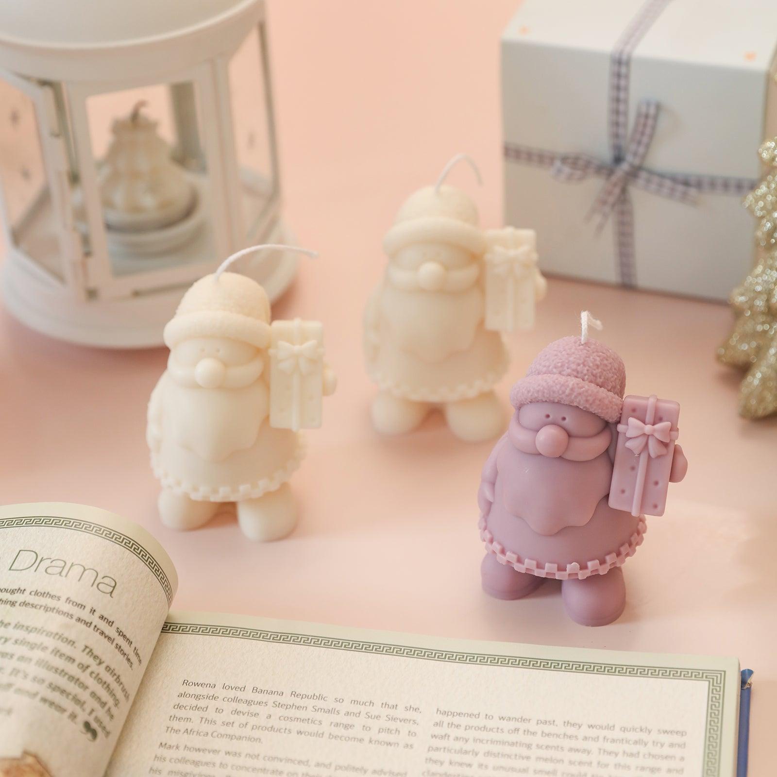 Gift-Giving Santa Claus Candle next to open book-Boowan Nicole