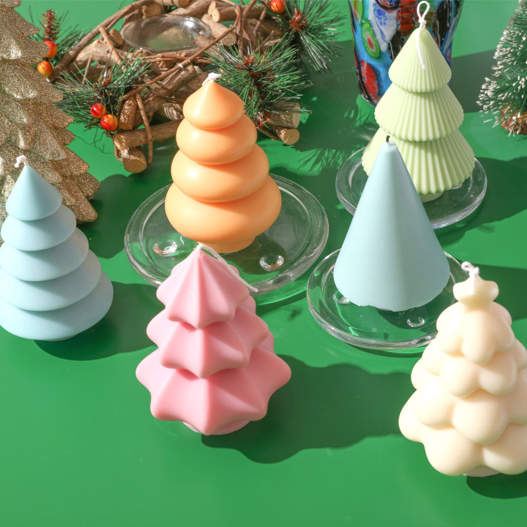 Christmas tree candles of various colors and shapes on the table - Boowan Nicole