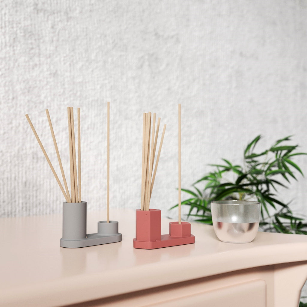 The red and gray Hexagon Incense Holder on the table holds incense sticks and matches on the other side - Boowan Nicole