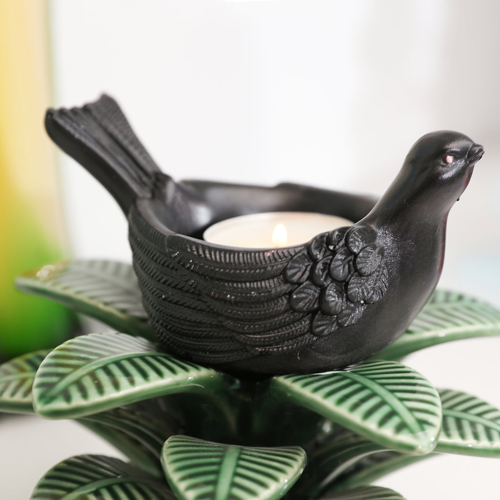 A black Joyful Bliss Bird Tealight Candle Holder.