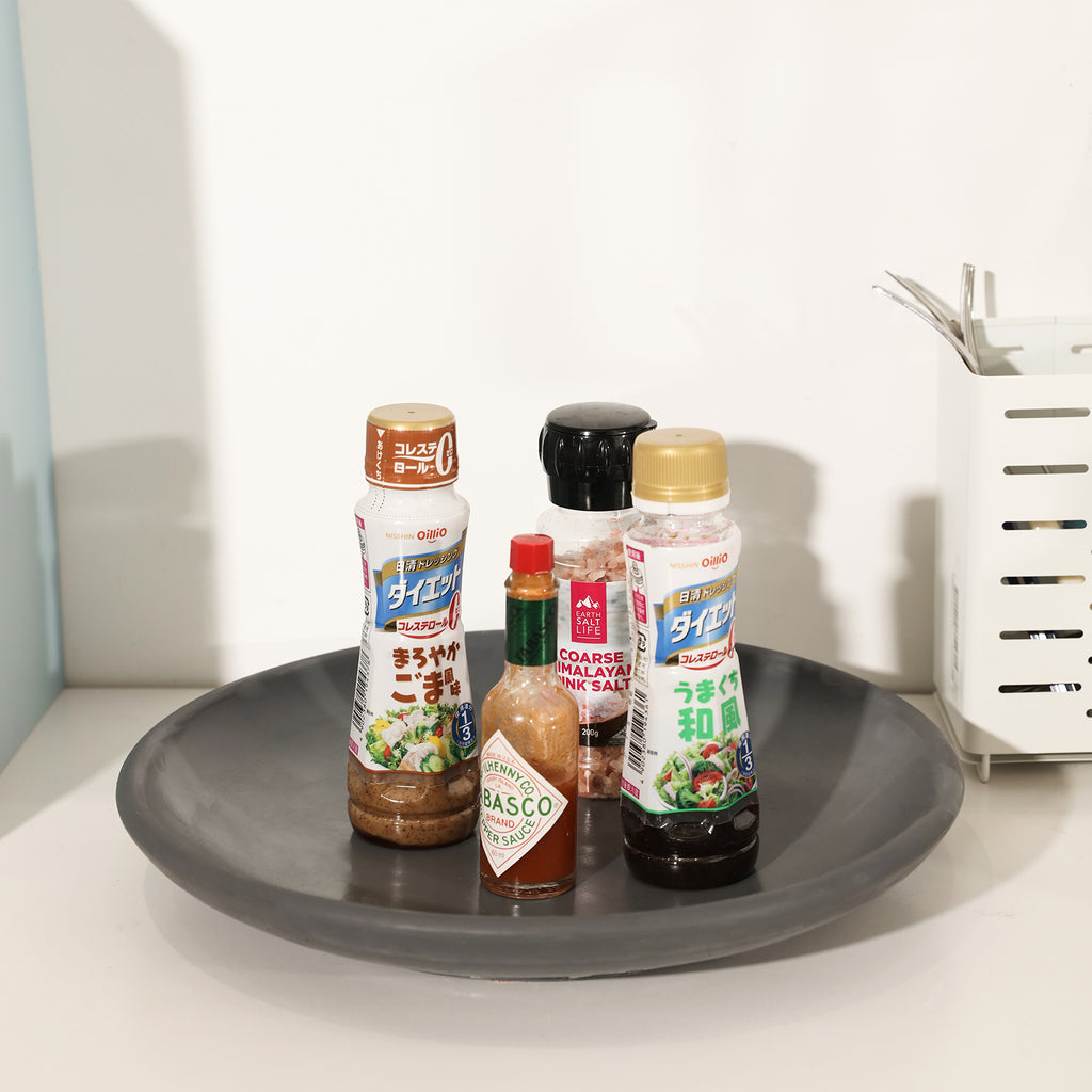 Condiments are placed on a tray in the kitchen.