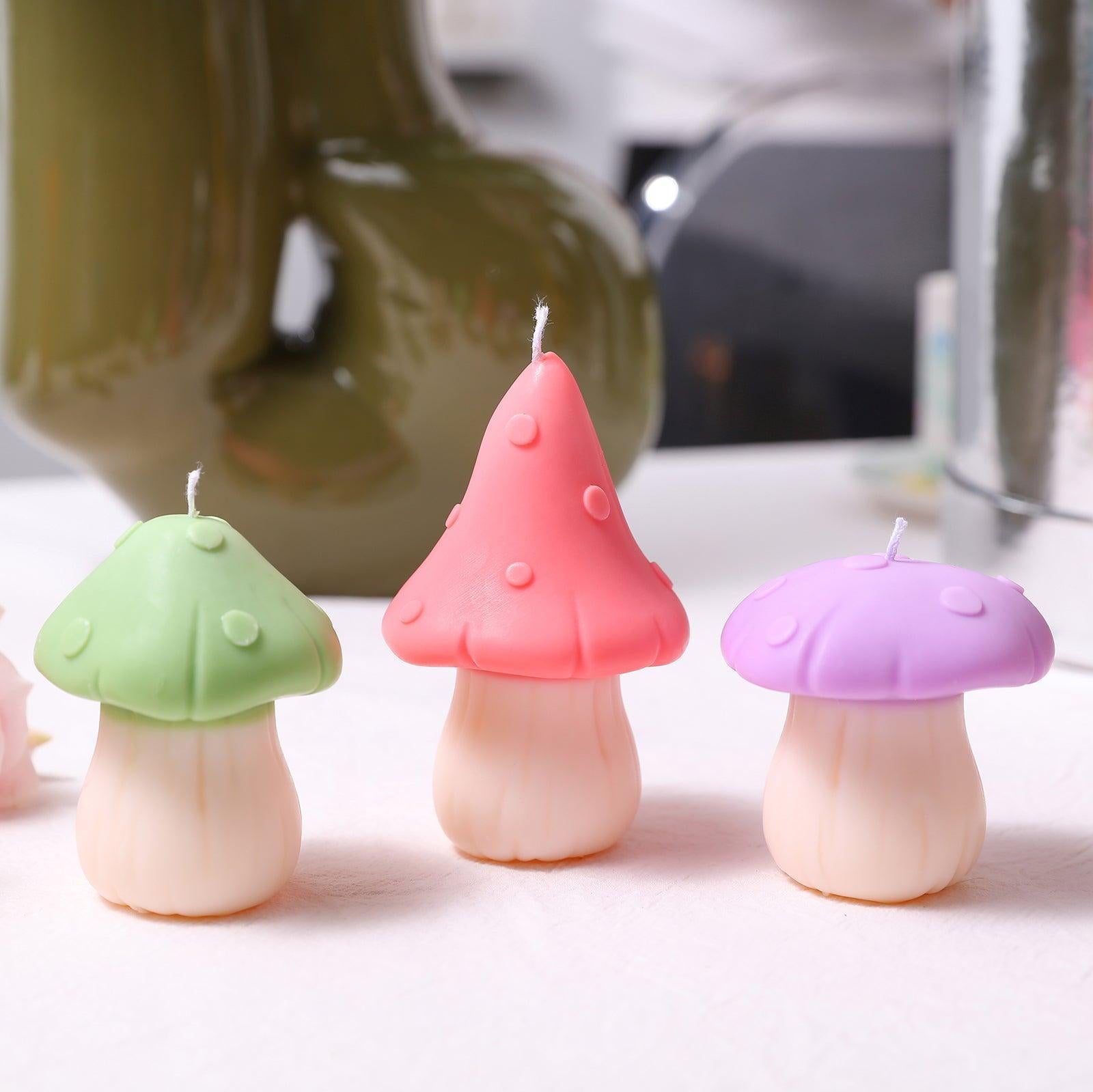 Mushroom candles in green, purple and pink colors, designed by Boowan Nicole.
