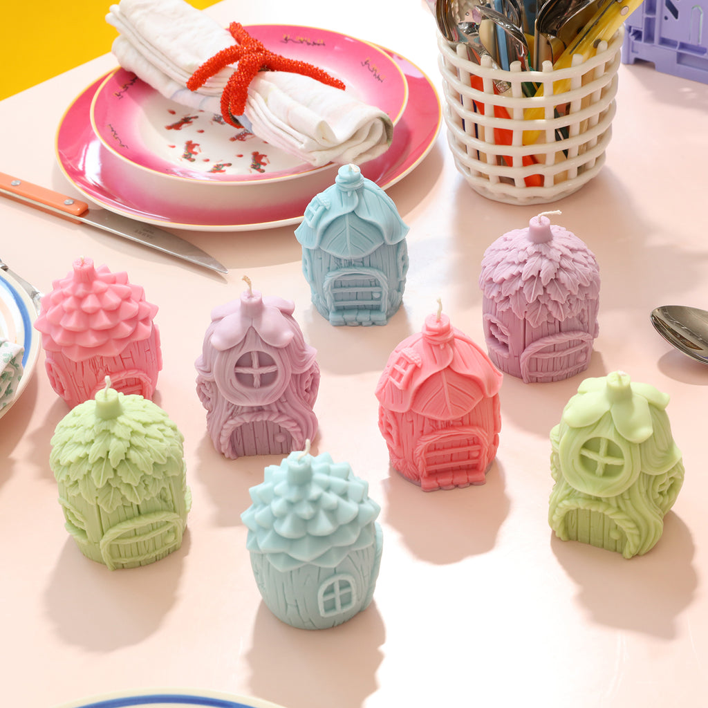 Miniature fairy house candles in four designs and multiple colors arranged on tabletop - Boowan Nicole