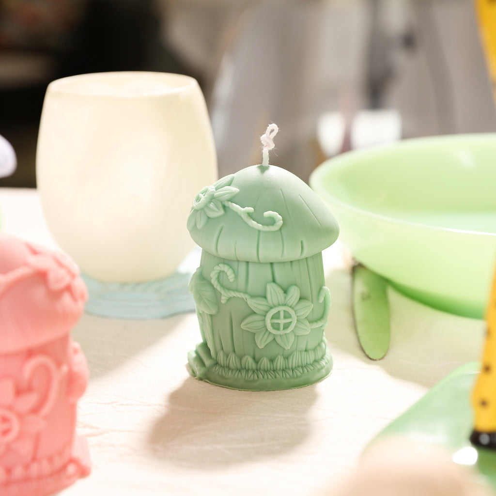 Green Mushroom House Candle on the dining table by Boowan Nicole.